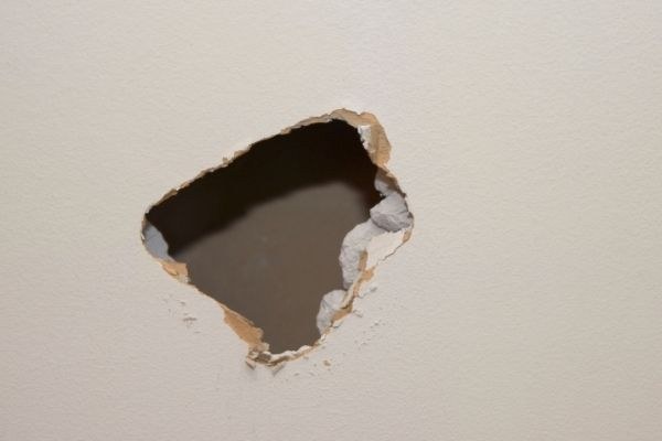 Towel rail wall damage before repair